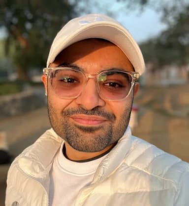 Hardeep in a cap and puffer jacket, outdoor selfie
